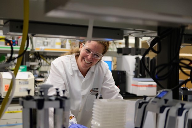DNASU scientist smiling in lab. Photo courtesy of ASU Media Relations